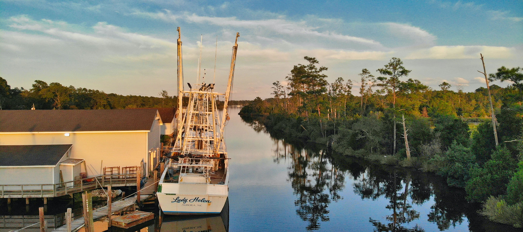 Fishing boat docked on a river.