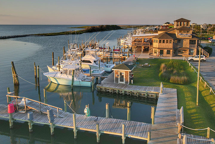 White boats docked at a marina.