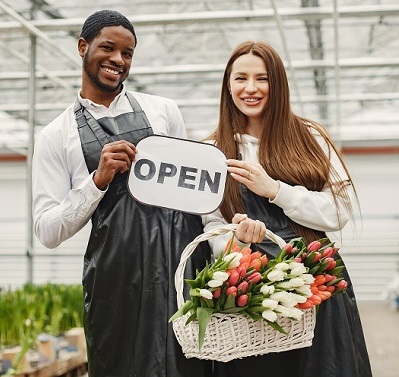 Employees with We Are Open Sign