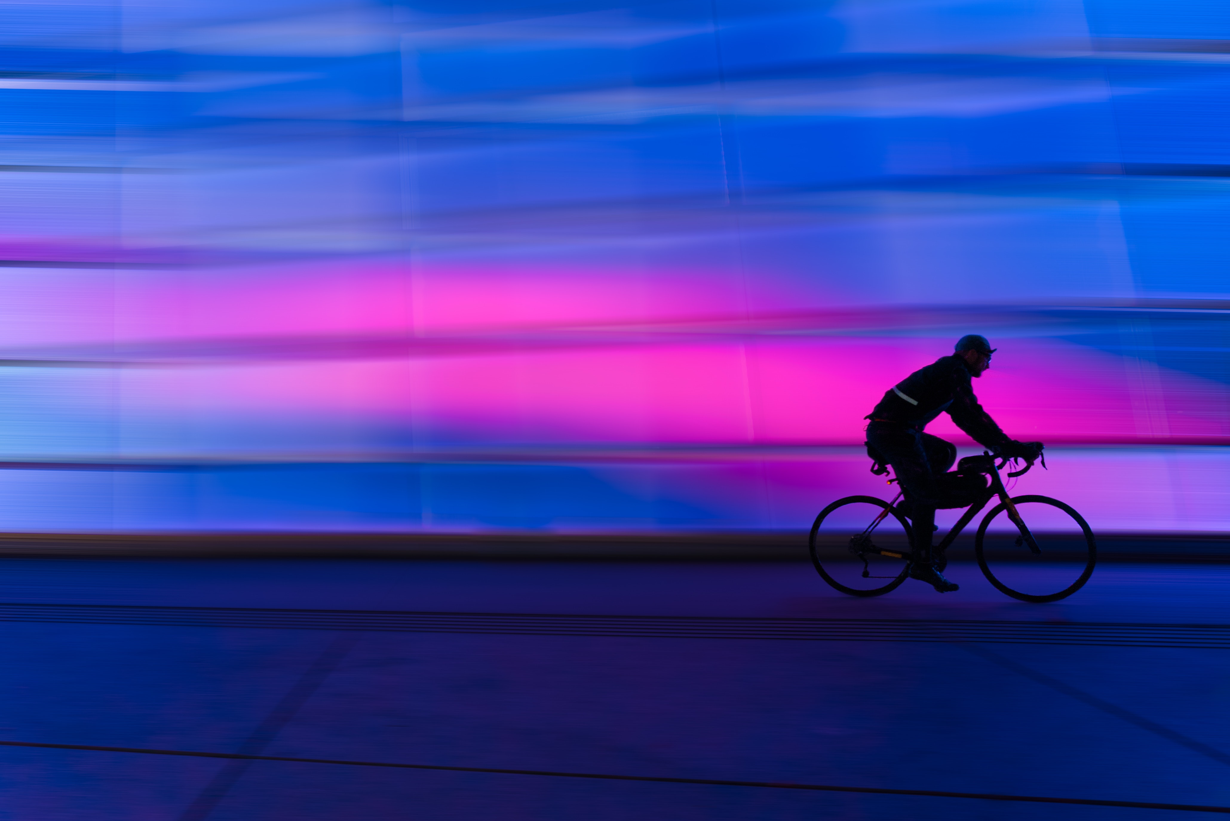 cyclist at night in purple blur effect