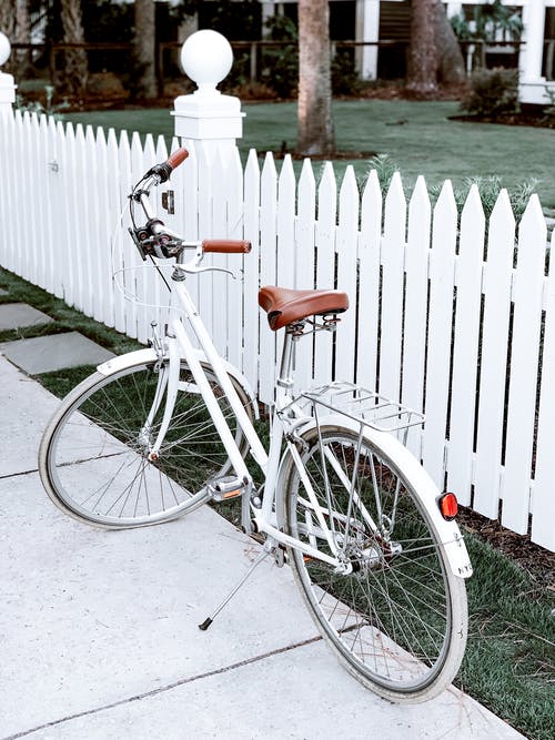 White Bike in front of White Fence