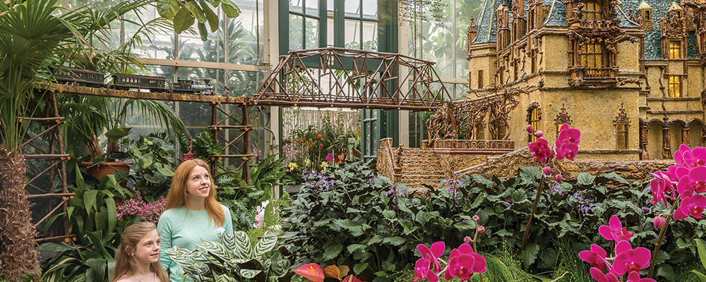 Biltmore Conservatory full of flowers and two girls looking around