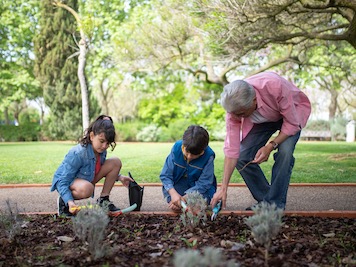 Jessica Stuart and her grandchildren Rose and Charlie planting flowers together