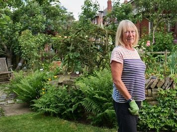 Ann Summers standing in front of her flower garden3
