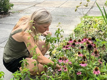 Ann Summers standing in front of her flower garden3