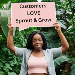 lady in greenhouse holding 'Customers love Sprout & Grow' sign