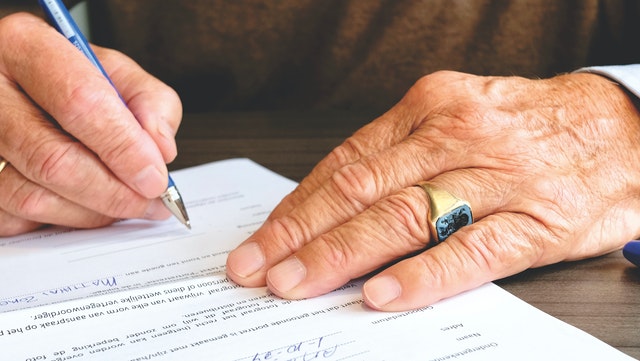 Hands Signing Forms