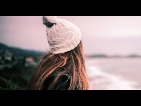 a back of a girl wearing a white hood