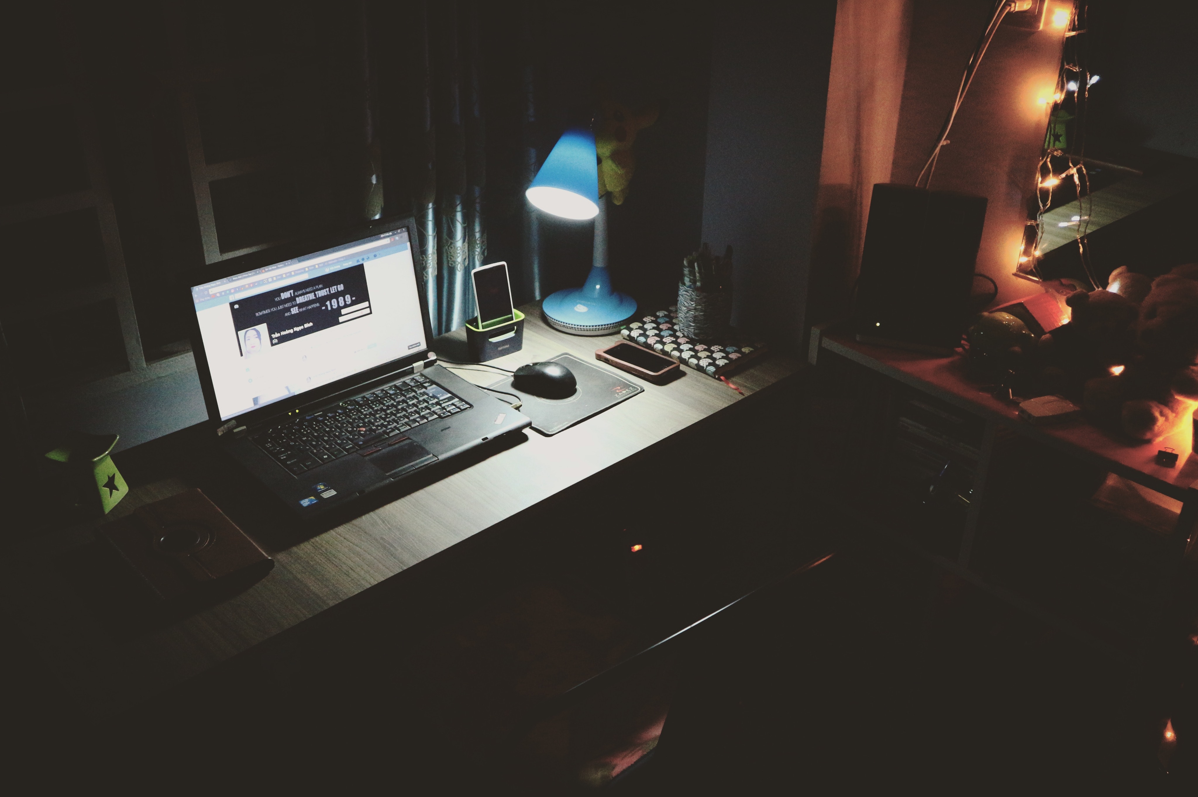 Dark desk with web development at night.