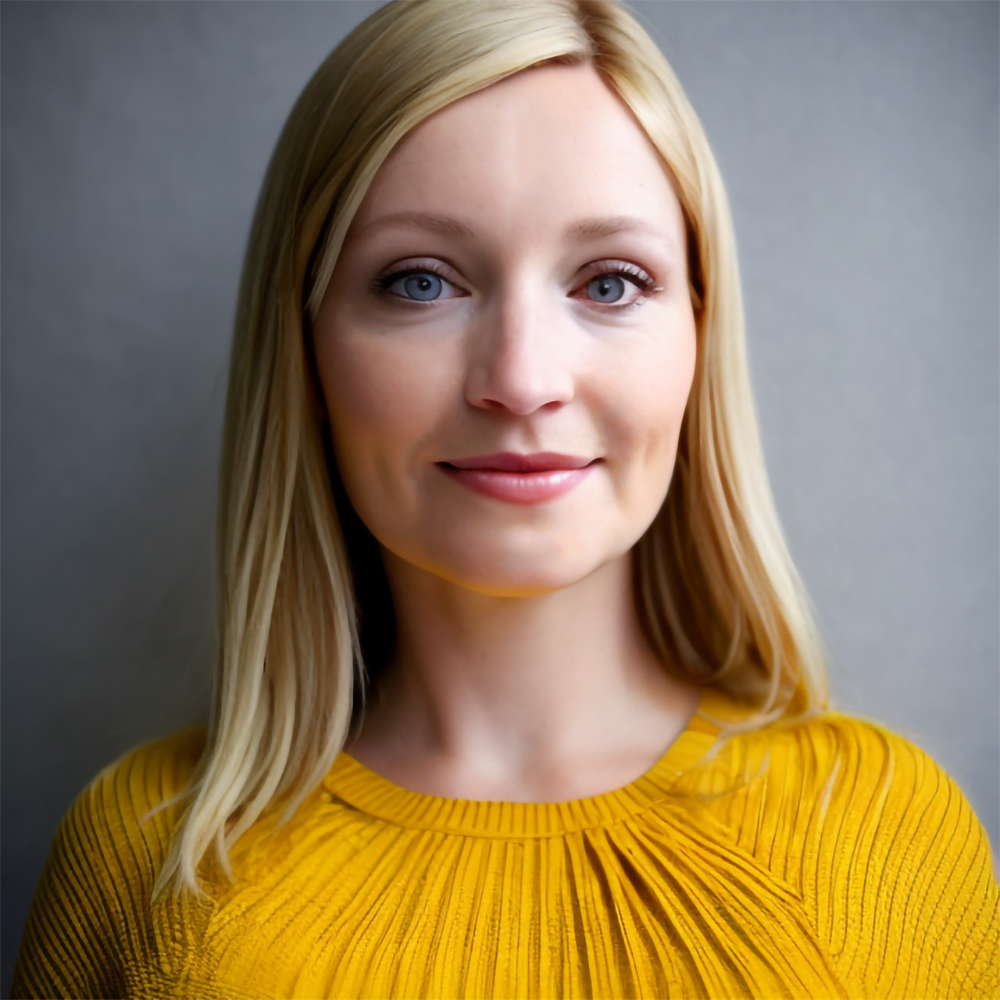 Woman with blonde hair wearing a yellow shirt