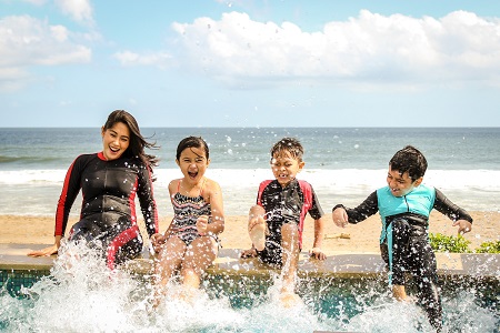 family having fun at the beach