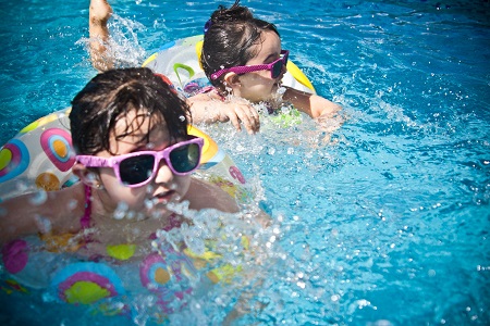 two kids on floats in a pool