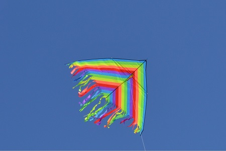 rainbow trangle shape kite in the sky