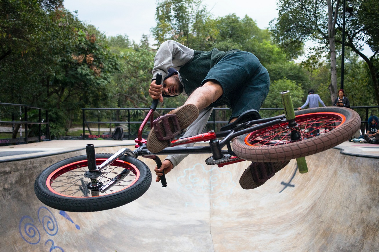 person on a bmx stunt bike in the air