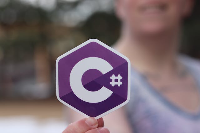 Someone holding up a C# logo