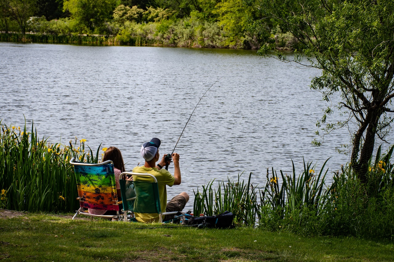 people fishing near a lake