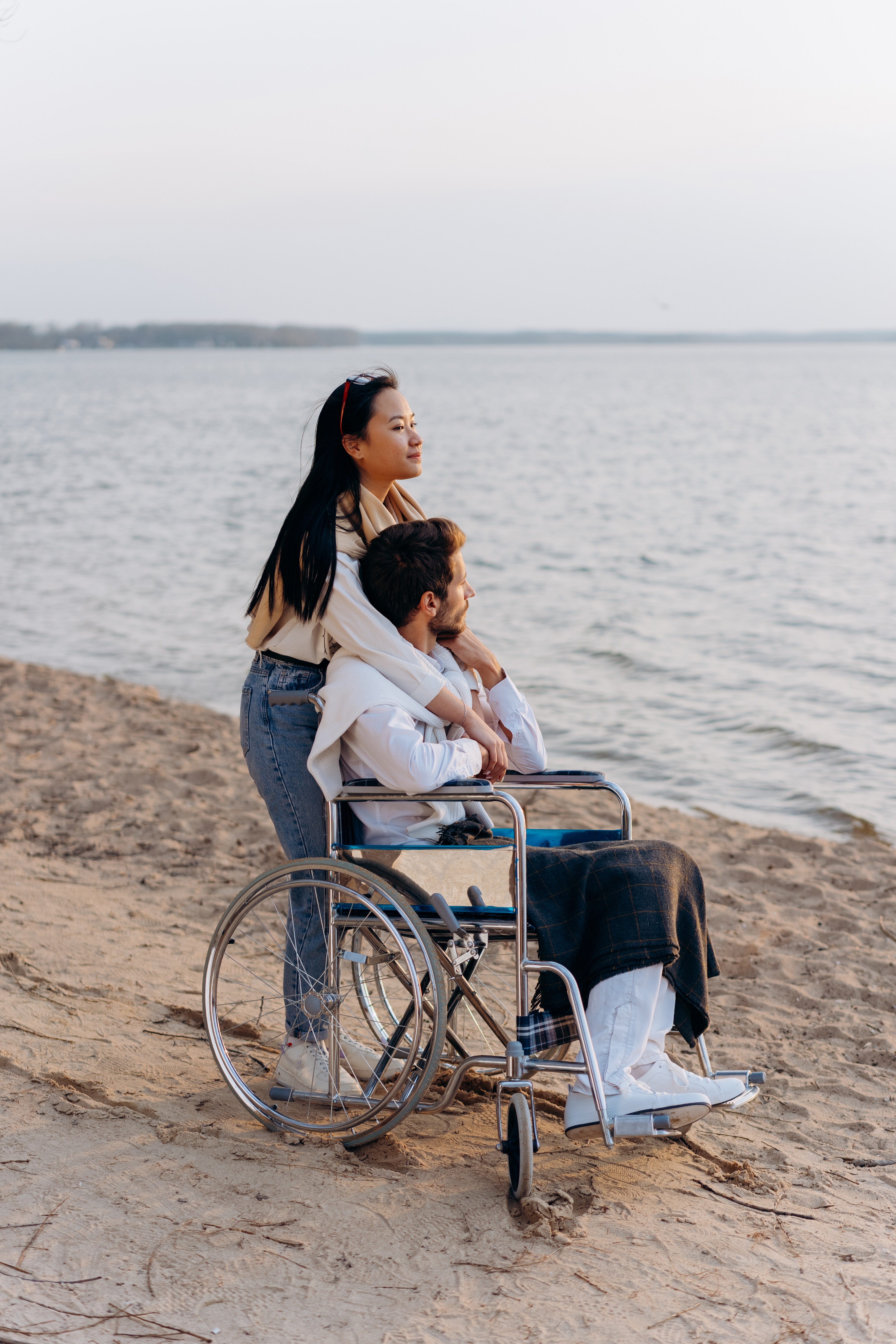 Beach Wheelchair - a man on a wheelchair with his significant other