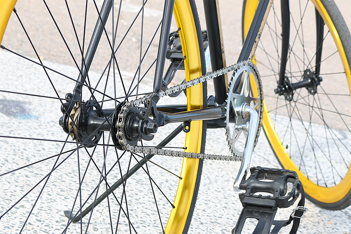 yellow bike with a golden chain