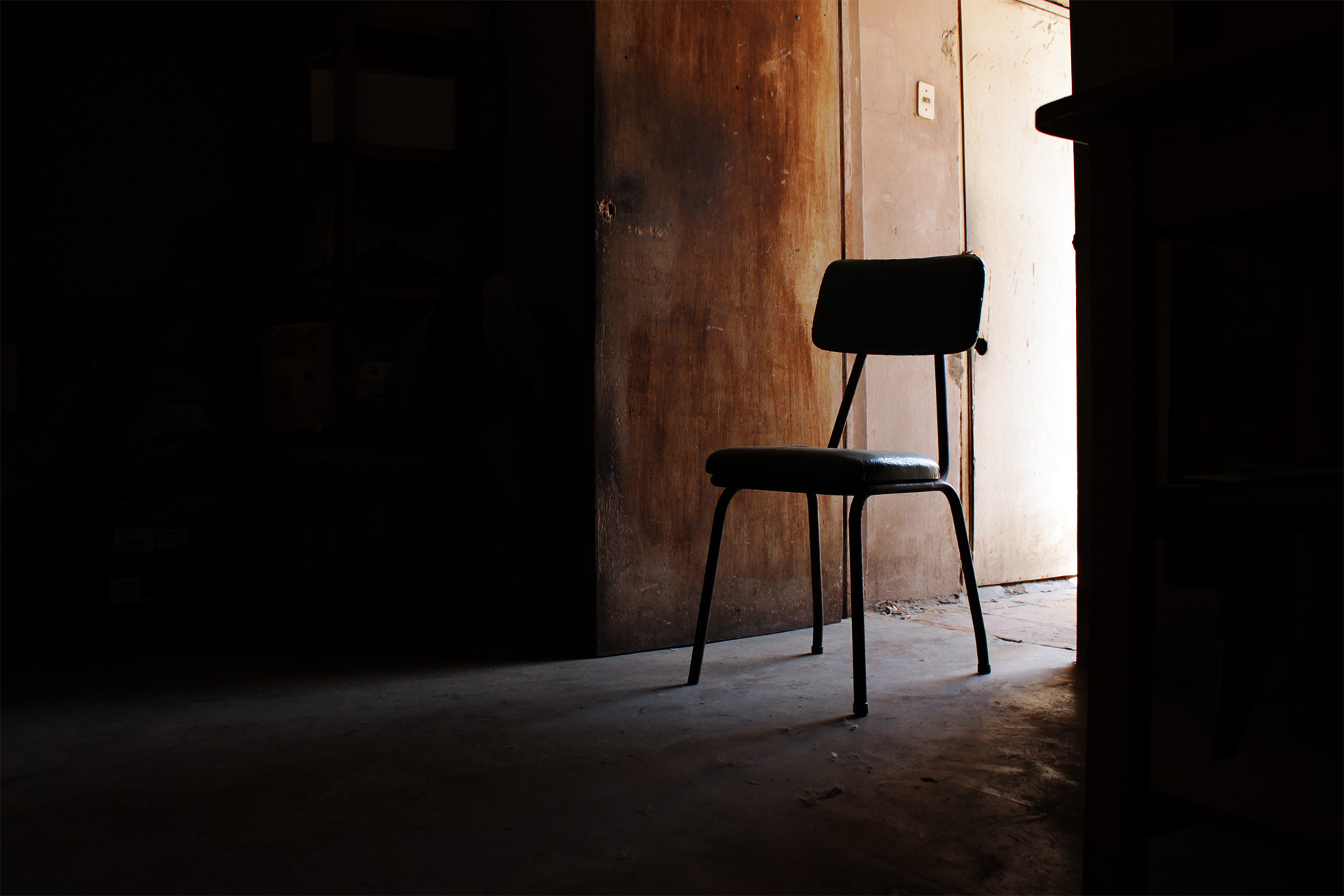 Just a chair in a dark room